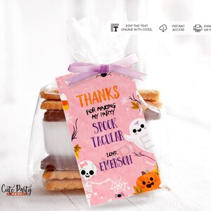 May include: Pink and orange Halloween favor tag with a ghost, skeleton, and pumpkin. The tag says "Thanks for making my party Spooktacular. Love, Emerson."