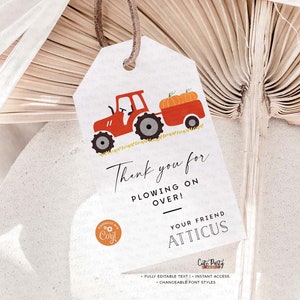 May include: Red tractor with a trailer full of pumpkins. The tractor is on a field of grass. The text on the tag says "Thank you for plowing on over! Your friend Atticus".