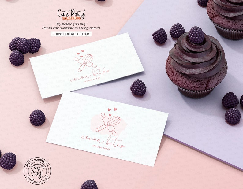 May include: Two white business cards with the text "cocoa bites artisan cakes" and a pink illustration of a whisk and rolling pin. The cards are on a pink surface with blackberries.