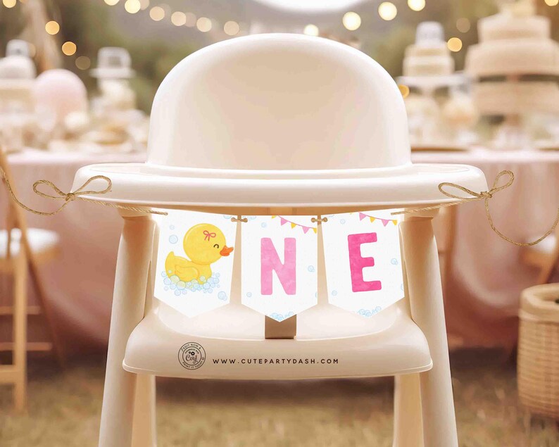 May include: A yellow rubber ducky with a pink bow sits on a white high chair with a pink and yellow banner that reads "ONE" and the text "www.cutepartydash.com".