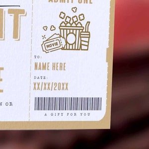 May include: A movie night gift certificate with a gold design. The certificate has a space to write in a name and date. The text on the certificate reads "Movie Night" and "A Gift For You".