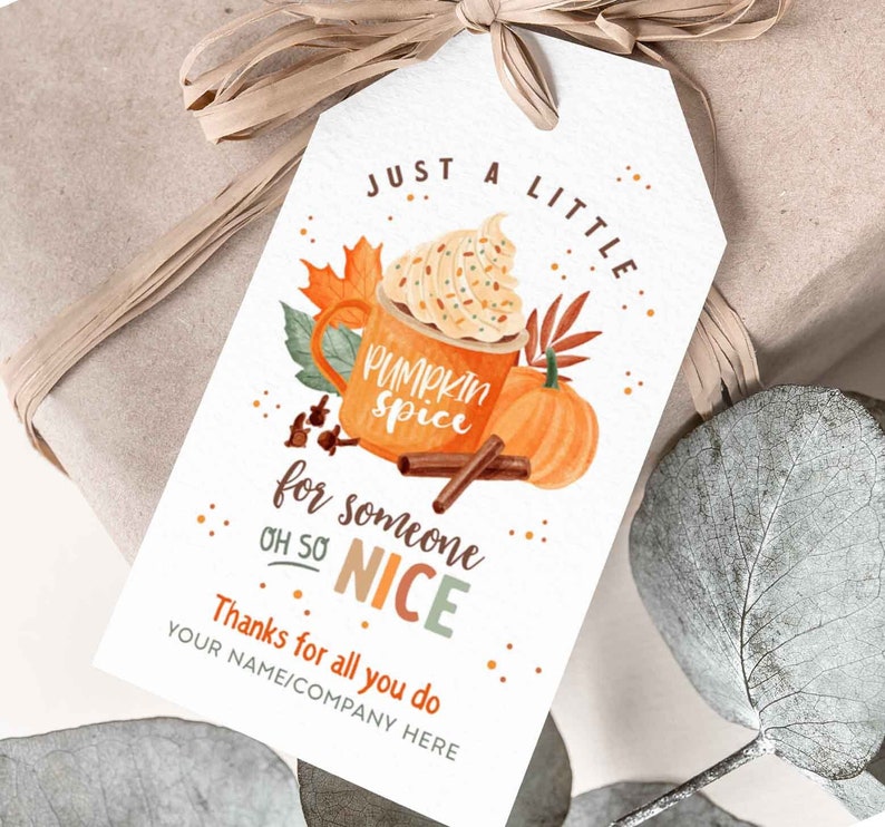 May include: A white gift tag with a fall-themed design featuring a cup of pumpkin spice latte with whipped cream and sprinkles, a pumpkin, and cinnamon sticks. The text on the tag reads "Just a little pumpkin spice for someone oh so nice. Thanks for all you do. Your name/company here."