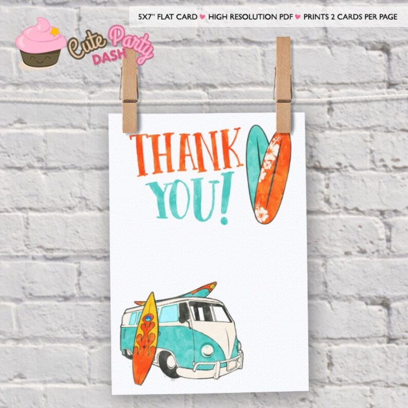 May include: A white card with the words "THANK YOU!" in orange and teal. The card features illustrations of surfboards and a teal and white van. The card is held by two wooden pegs against a white brick wall.