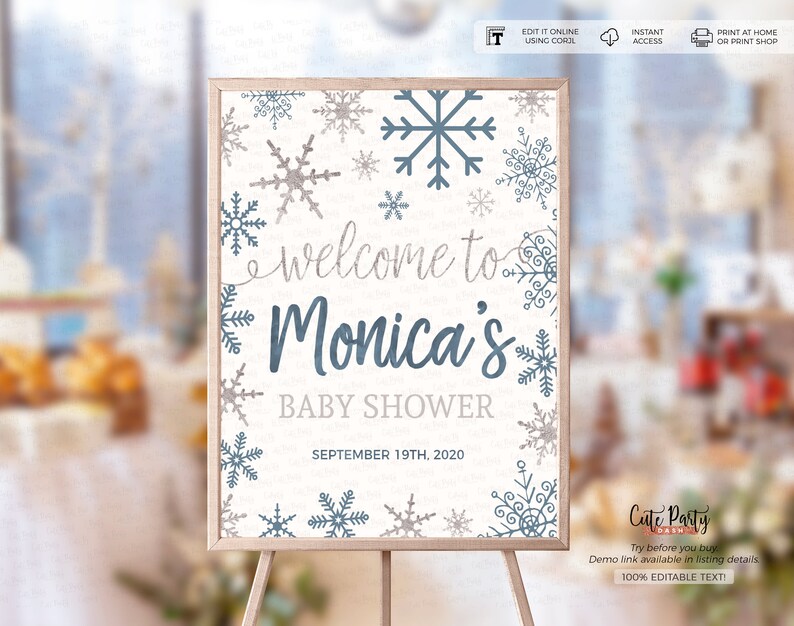 May include: A white welcome sign with a blue and gray snowflake design. The sign says "Welcome to Monica's Baby Shower" and "September 19th, 2020".