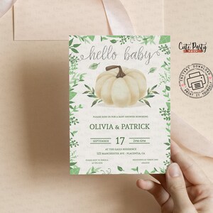 May include: A printable baby shower invitation with a white pumpkin and green leaves. The text reads "hello baby" and includes the names Olivia & Patrick, the date September 17, and the time 2PM-4PM. The invitation also includes the address 123 Manchester Ave - Placentia, CA.