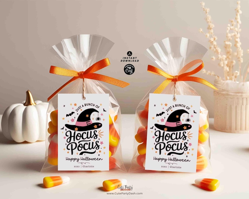 May include: Two clear cellophane bags filled with candy corn and tied with orange ribbon. Each bag has a white tag with a black witch hat, stars, and the text "Just a bunch of Hocus Pocus. Happy Halloween xoxo Charlotte".