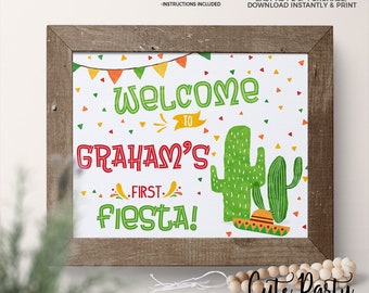 Puede incluir: Señal imprimible de 20,3 x 25,4 cm para una fiesta de primer cumpleaños con temática de cactus y sombrero. El cartel dice "¡Bienvenido a la primera fiesta de Graham!"