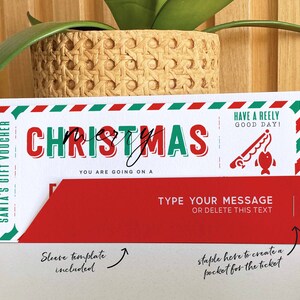 May include: A red and green Christmas gift voucher with the text "SANTA'S GIFT VOUCHER" and "CHRISTMAS". The voucher has a red sleeve template included and instructions to staple the sleeve to create a pocket for the ticket. The text "HAVE A REELY GOOD DAY!" is printed on the voucher.