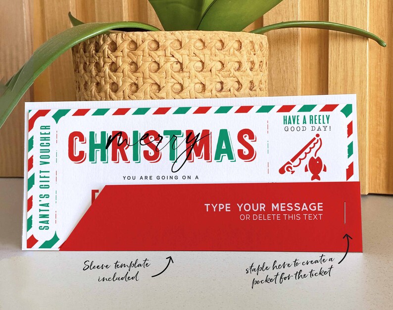 May include: A red and green Christmas gift voucher with the text "SANTA'S GIFT VOUCHER" and "CHRISTMAS". The voucher has a red sleeve template included and instructions to staple the sleeve to create a pocket for the ticket. The text "HAVE A REELY GOOD DAY!" is printed on the voucher.