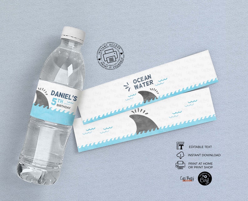 May include: Water bottle labels with a blue and white ocean wave design and a gray shark fin. The label says "Ocean Water" and has the text "Daniel's 5th Birthday".