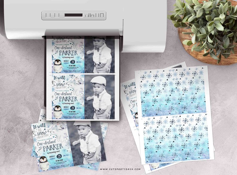 May include: Printable party invitation featuring a penguin with a blue and white winter wonderland background. The invitation says "It will snow much fun! One-derland Parker".