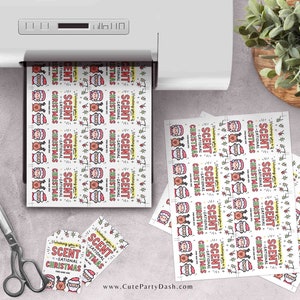 May include: A sheet of printable gift tags featuring a cartoon Santa Claus with the text "Scent-sational Christmas". The tags are printed on white paper with a red, green, and yellow color scheme.