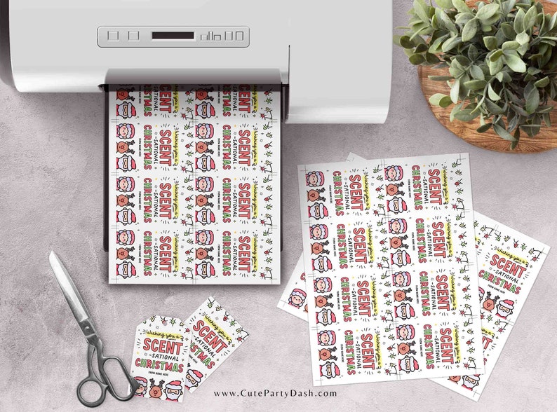 May include: A sheet of printable gift tags featuring a cartoon Santa Claus with the text "Scent-sational Christmas". The tags are printed on white paper with a red, green, and yellow color scheme.