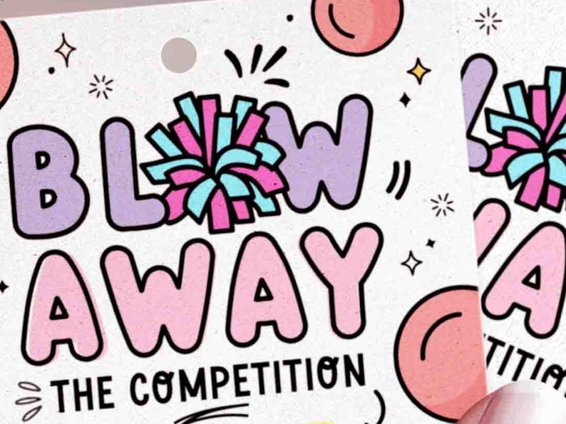 May include: A white card with the words "BLOW AWAY THE COMPETITION" in bubble letters. The word "BLOW" is in purple, and "AWAY" is in pink. A pom-pom graphic is above the word "BLOW".