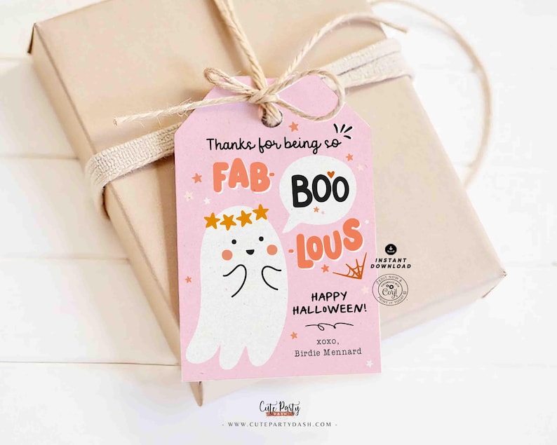 May include: A pink Halloween gift tag with the words "Thanks for being so FAB-BOO-LOUS!" and "Happy Halloween!" A cute ghost illustration is featured. The tag is tied to a wrapped gift with twine.