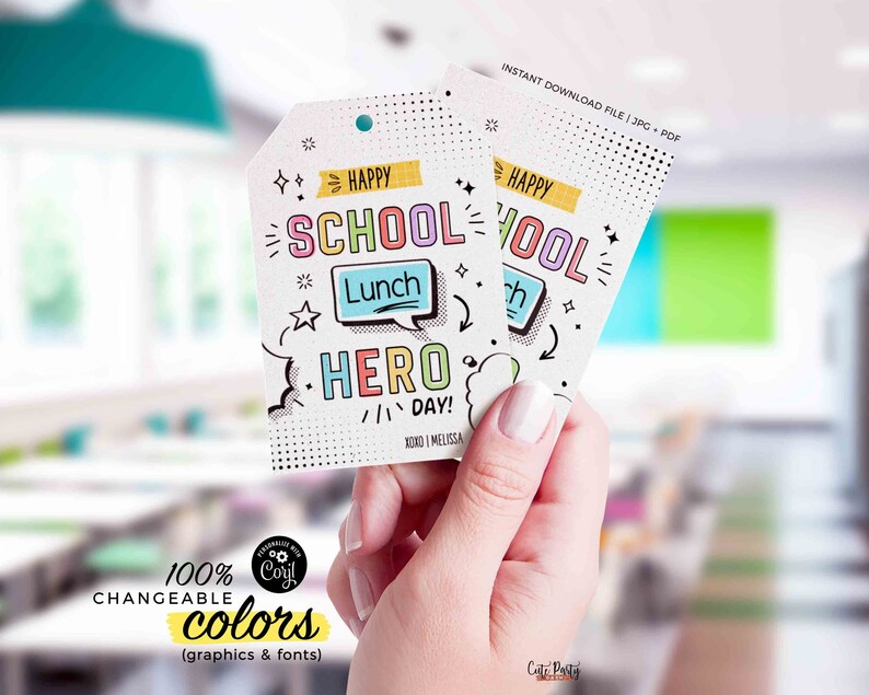 May include: Two printable tags with a colorful comic book style design. The text on the tags reads "Happy School Lunch Hero Day!" and "Happy School Lunch Hero Day!" The tags are held in a hand.