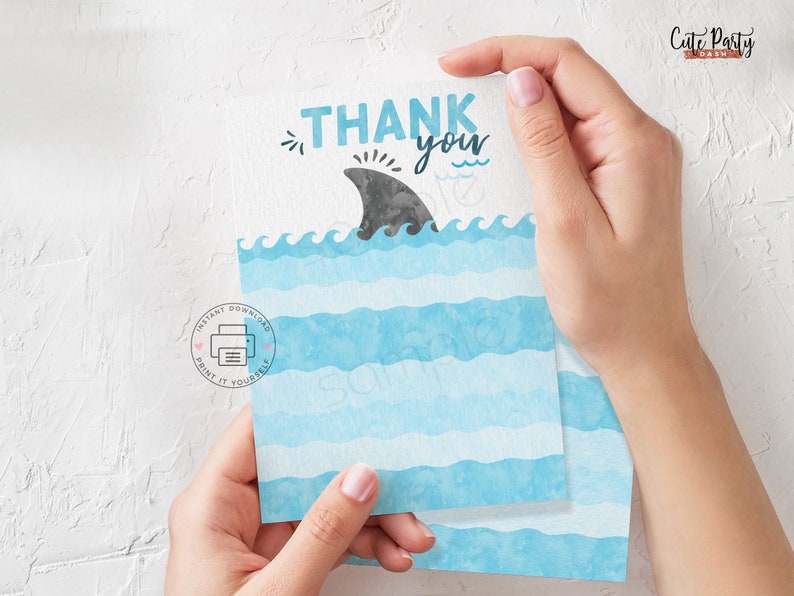 May include: Thank you card with a blue and white watercolour design. The card features a shark fin and the text "Thank you".