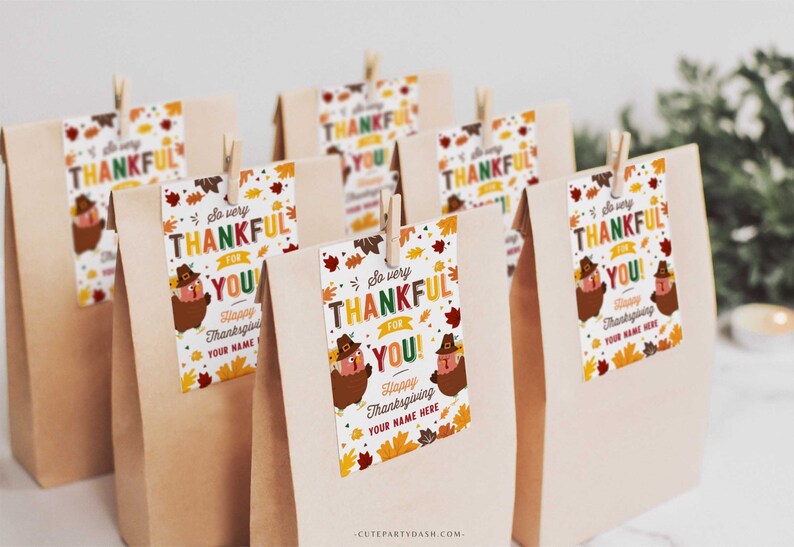 May include: A set of 8 brown paper bags with colorful Thanksgiving gift tags attached. The tags feature a cartoon turkey with the text "So very thankful for you!" and "Happy Thanksgiving, Your name here".