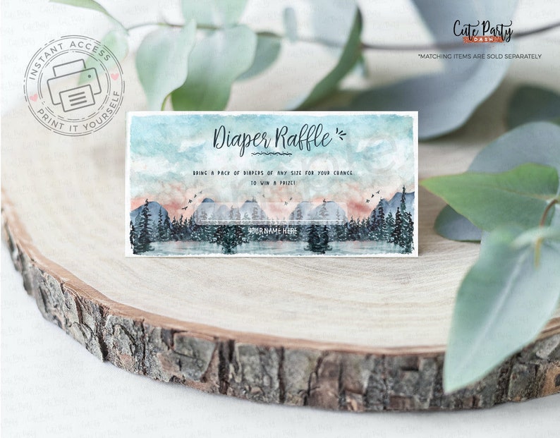 May include: A printable diaper raffle ticket with a watercolor mountain scene. The text reads "Diaper Raffle" and "Bring a pack of diapers of any size for your chance to win a prize".