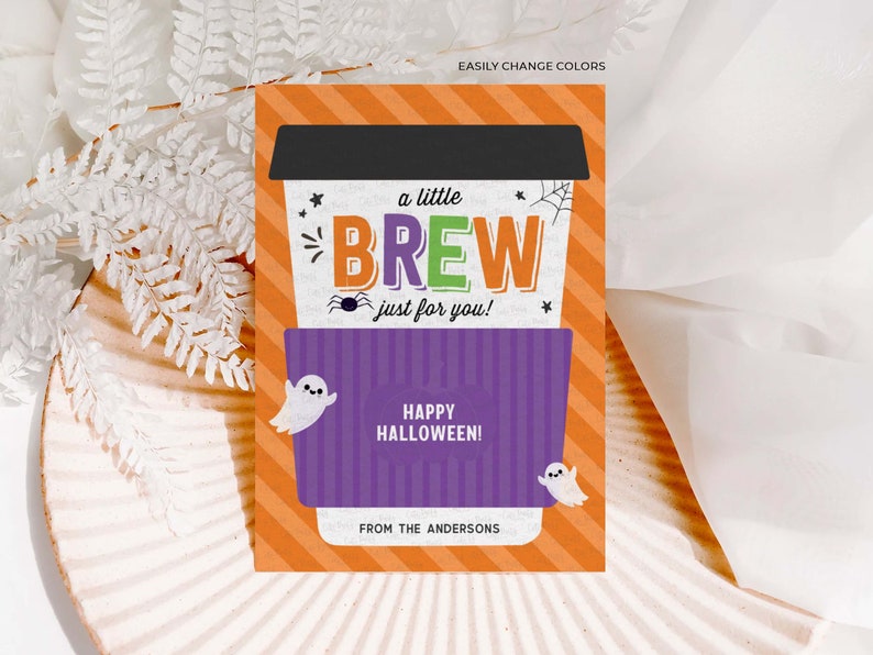 May include: A Halloween-themed gift card with an orange and white striped background. The card features a coffee cup design with the words "a little BREW just for you!" and "HAPPY HALLOWEEN!" along with two ghost illustrations. The card is personalized "FROM THE ANDERSONS."