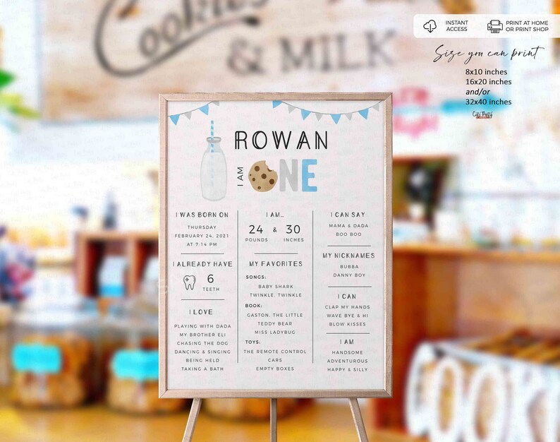 May include: A blue and gray printable first birthday sign for a boy named Rowan. The sign features a milk bottle with a cookie, a banner, and text that says "Rowan One". The sign also includes details about Rowan's birth, weight, height, and favorite things.