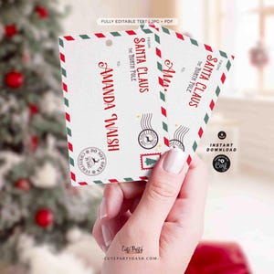 May include: A printable Christmas card template with a red and green border. The card is addressed to Amanda Walsh from Santa Claus at the North Pole. The card has a red and green border and a stamp with a reindeer.