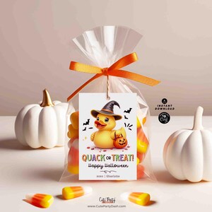May include: A printable Halloween treat bag tag featuring a cartoon rubber duck wearing a witch hat and holding a jack-o-lantern. The tag says "Quack or Treat! Happy Halloween 2020 | Charlotte".