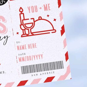 May include: A white card with red and pink stripes. The card has a red and white illustration of a candle, wine glass, and a cloche. The text "YOU + ME" is printed in red. The card has a section for a name, date, and a barcode. The text "BON APP&Eacute;TIT" is printed in red.