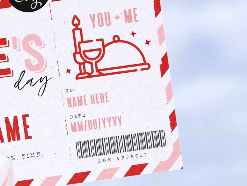 May include: A white card with red and pink stripes. The card has a red and white illustration of a candle, wine glass, and a cloche. The text "YOU + ME" is printed in red. The card has a section for a name, date, and a barcode. The text "BON APP&Eacute;TIT" is printed in red.