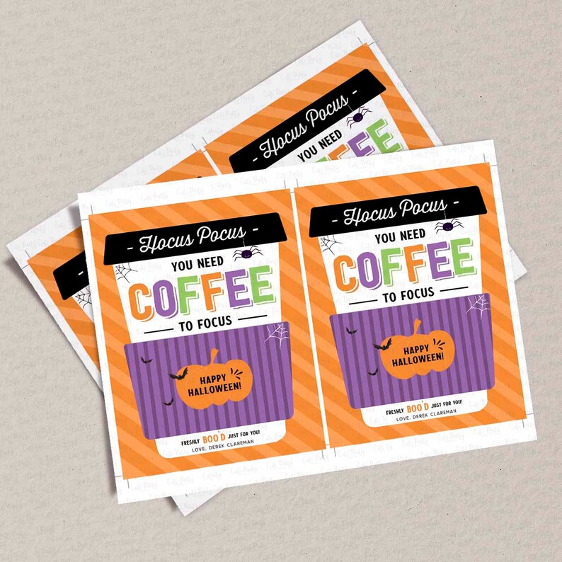 May include: Two printable gift tags with an orange and white striped background. The tags feature a purple coffee cup with a spider web design and the text "Hocus Pocus - You Need Coffee To Focus". The coffee cup has a pumpkin with the text "Happy Halloween!" inside. The text "Freshly Boo'd Just For You" and "Love, Derek Clareman" are at the bottom of the tags.