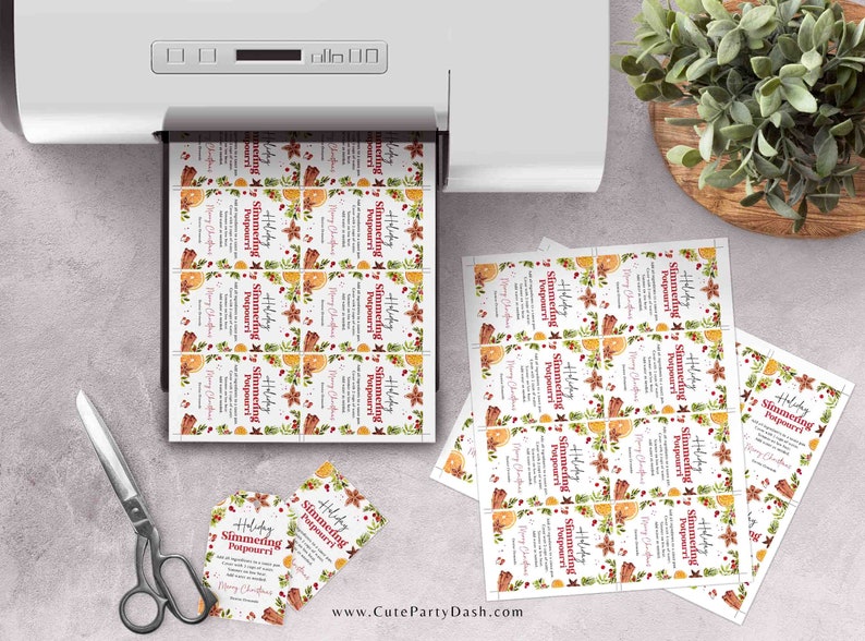 May include: Printable holiday gift tags featuring a watercolour design of oranges, cinnamon sticks, cloves, and greenery. The text on the tags reads "Holiday Simmering Potpourri".