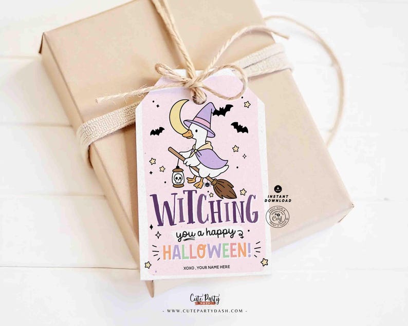 May include: A gift wrapped in tan paper with a light pink Halloween-themed tag. The tag features a cartoon goose dressed as a witch, the text "Witching you a happy Halloween!" and stars, bats, and a moon.