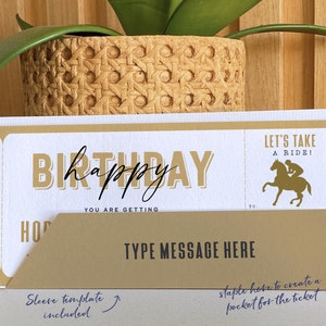 May include: A gold and white printable birthday gift voucher with the text "Happy Birthday" and "Let's Take A Ride!" with a silhouette of a person riding a horse. The voucher has a sleeve template included and instructions to create a pocket for the ticket.