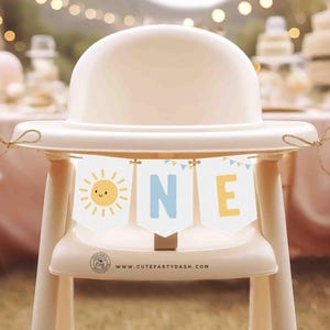 May include: A white high chair with a yellow sun and blue letter bunting that says "ONE" hanging from the top. The bunting is strung with a brown twine. The chair is decorated with a website address: www.cutepartydash.com