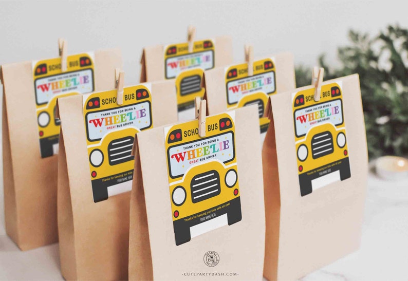 May include: A set of brown paper bags with yellow school bus thank you tags. The tags feature a cartoon school bus with the text "Thank you for being a Wheelie Great Bus Driver".