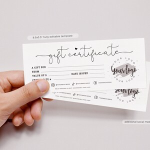 May include: A white gift certificate template with black handwritten font. The text reads "gift certificate". The template includes fields for "A gift for", "From", "Value of &pound;", "Date Issued", and social media icons. The template also includes a grey watercolour logo with the text "Your logo".