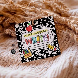 May include: A square tag with a black and white speckled background, featuring the word "WRITE!" in colorful letters. The tag includes illustrations of a red apple, pencils, and a crayon box. Text reads "Let start this year off" and "XOXO I NAME HERE".
