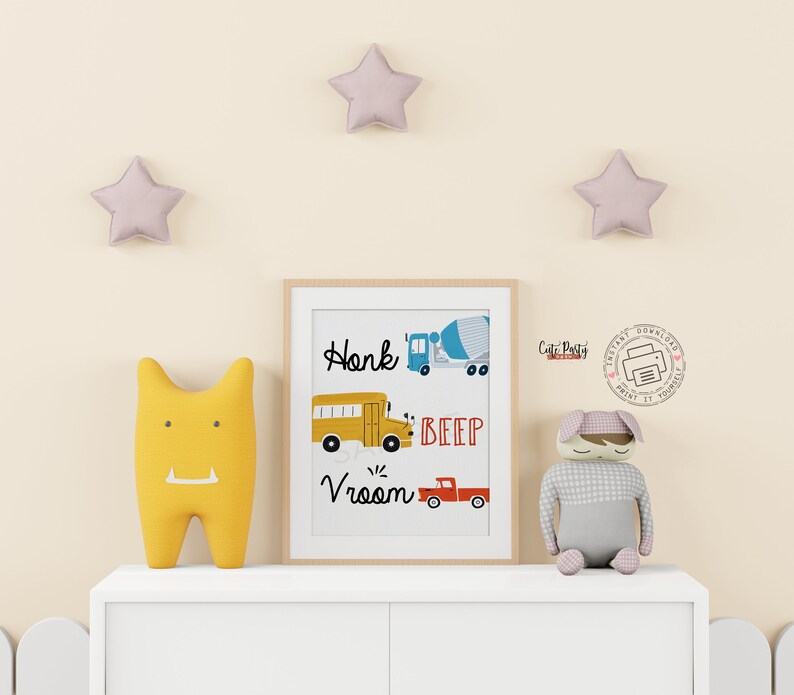 May include: A printable wall art design featuring a yellow school bus, a red pickup truck, and a blue cement mixer. The text on the print reads "Honk Beep Vroom".