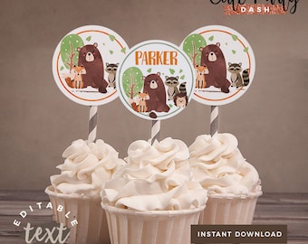 May include: Three cupcake toppers with a woodland theme. Each topper features a brown bear, a fox, a raccoon, and a hedgehog. The toppers are printed on white circles with a green and brown border. The text "PARKER" is printed on one of the toppers.