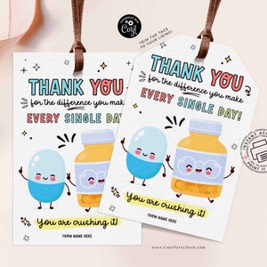 May include: Two cartoon pill characters, one blue and one yellow, holding hands and smiling. The text reads "Thank you for the difference you make every single day! You are crushing it!" with a space for a name.