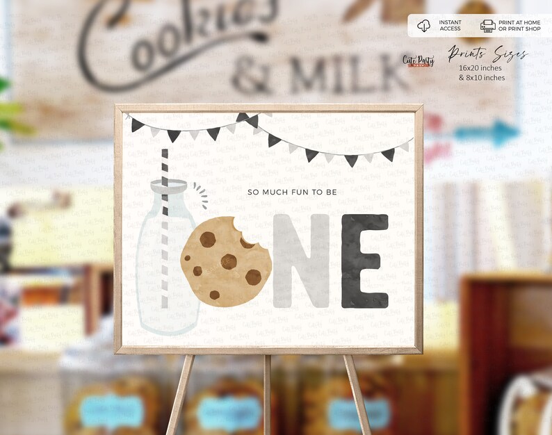 May include: A printable sign for a first birthday party featuring a milk bottle, a cookie, and the word "ONE" in black, grey, and white. The text "So much fun to be" is above the number one. The sign is on an easel.