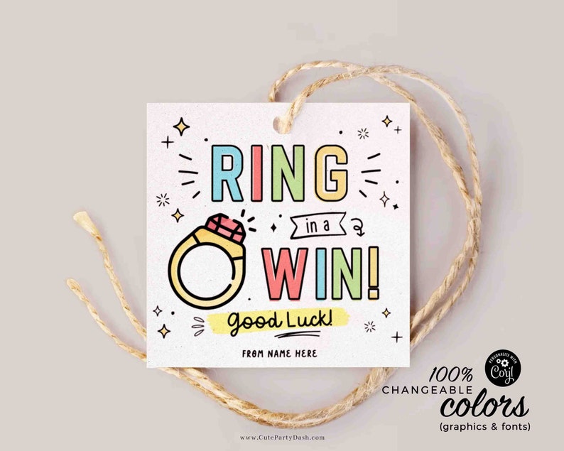 May include: A colorful tag with a ring and the text "RING in a WIN! Good Luck!"  The tag is tied with twine and has a white background with pink, yellow, blue, and green accents.
