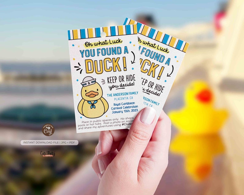 May include: Two yellow duck-shaped cards with blue and white stripes. The text on the cards reads "Oh what Luck YOU FOUND A DUCK! KEEP OR HIDE you decide!" and "Oh what Luck FOUND A DUCK! KEEP OR HIDE you decide!" The cards are held in a hand.