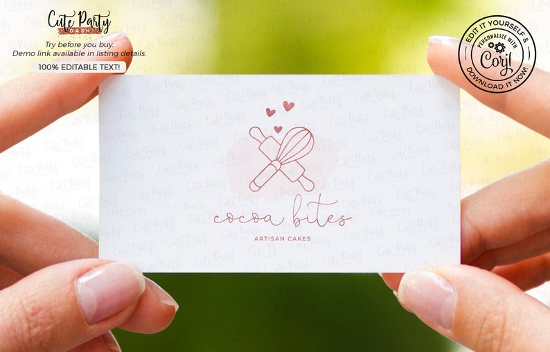 May include: A pink and white business card with the text "cocoa bites artisan cakes" and a logo of a rolling pin and whisk crossed over each other with three pink hearts above them.