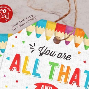 May include: A colourful gift tag with the text "You are all that and a bag of chips" with a row of colourful pencils at the top. The tag is trimmed with a brown string.