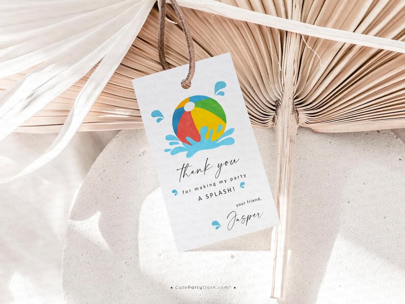 May include: A white gift tag featuring a colourful beach ball illustration and the words "thank you for making my party A SPLASH!" in black script. The tag is tied with a brown string.