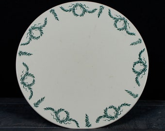 May include: White ceramic plate with a green leafy border design.