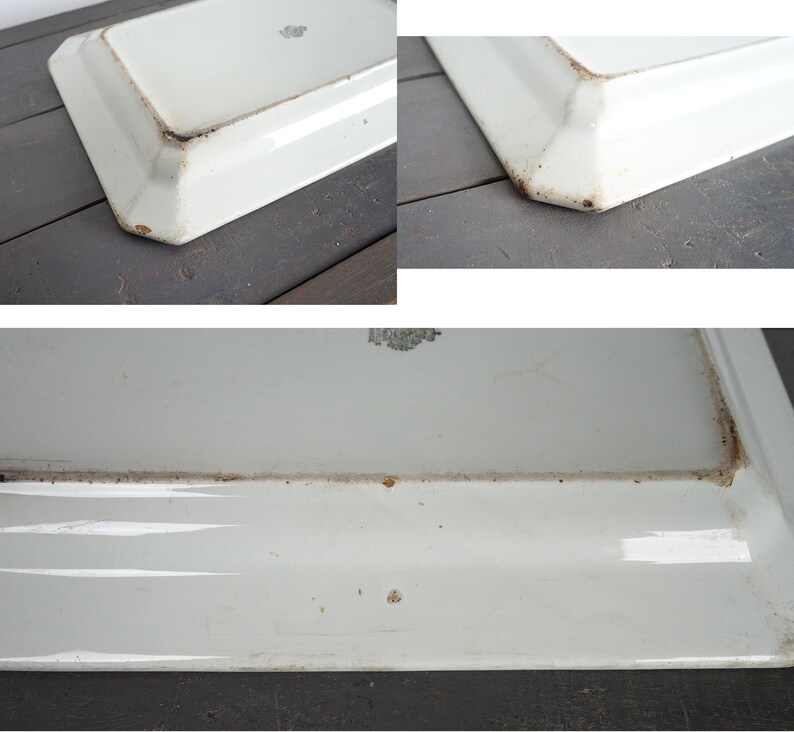 May include: White ceramic serving platter with a slightly raised rim and a slightly scalloped edge. The platter has a few brown stains on the bottom.