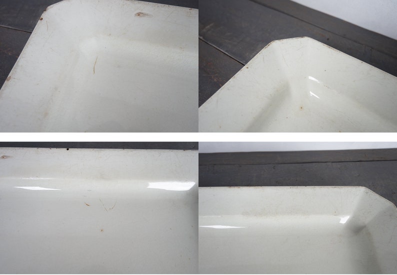 May include: A white enamel baking dish with a rectangular shape. The dish has a slightly worn surface with some scratches.