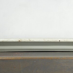 May include: A white rectangular ceramic serving tray with a slightly raised edge. The tray has a rustic, vintage look with subtle brown speckles throughout.